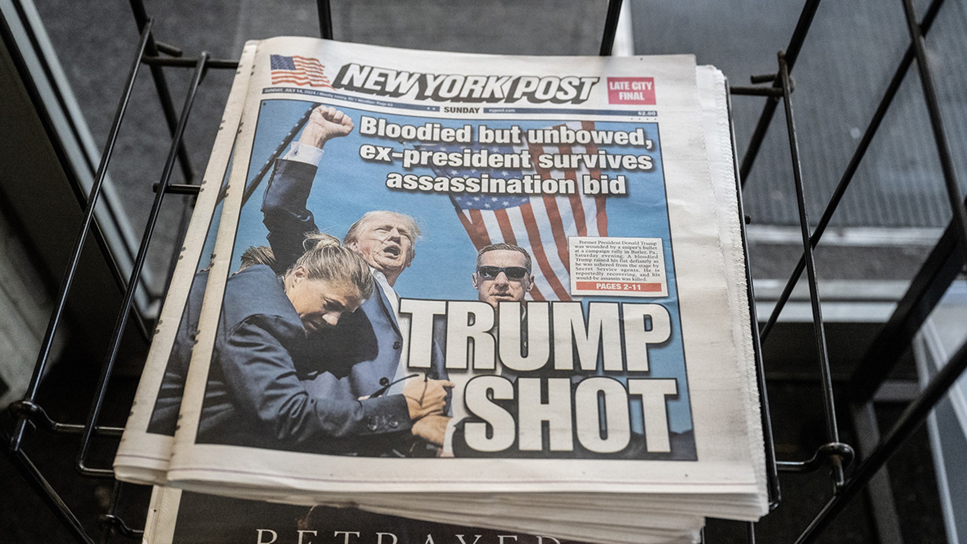 A copy of the New York Post featuring a front page article about the shooting at former US President Donald Trump's campaign event, in the Brooklyn borough of New York