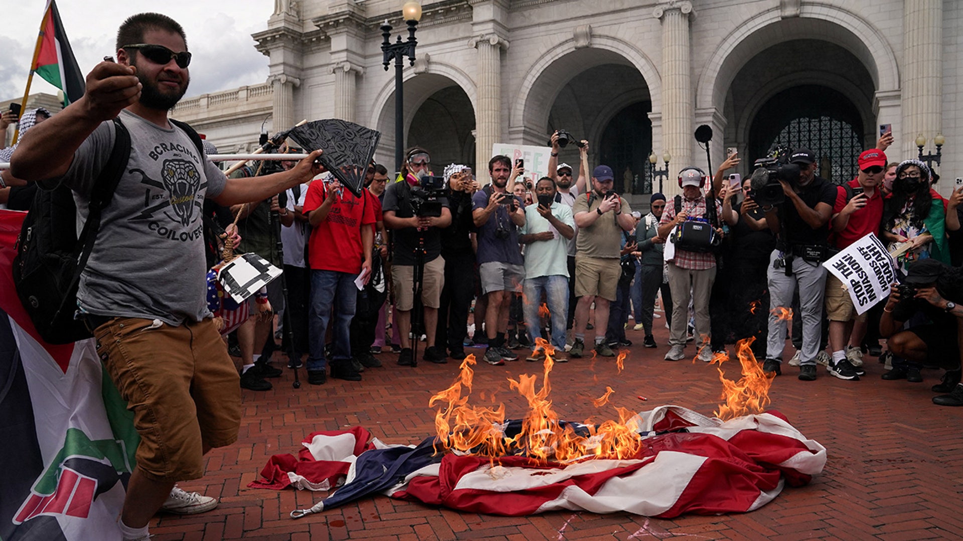Pro-Palestinian demonstrators burn a U.S. flag