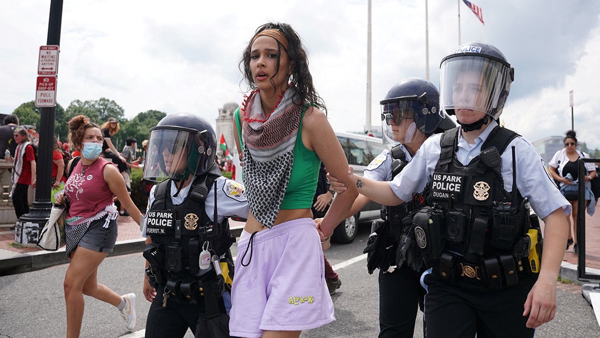 U.S. Park Police officers escort away a handcuffed demonstrator at a pro-Palestinian protest