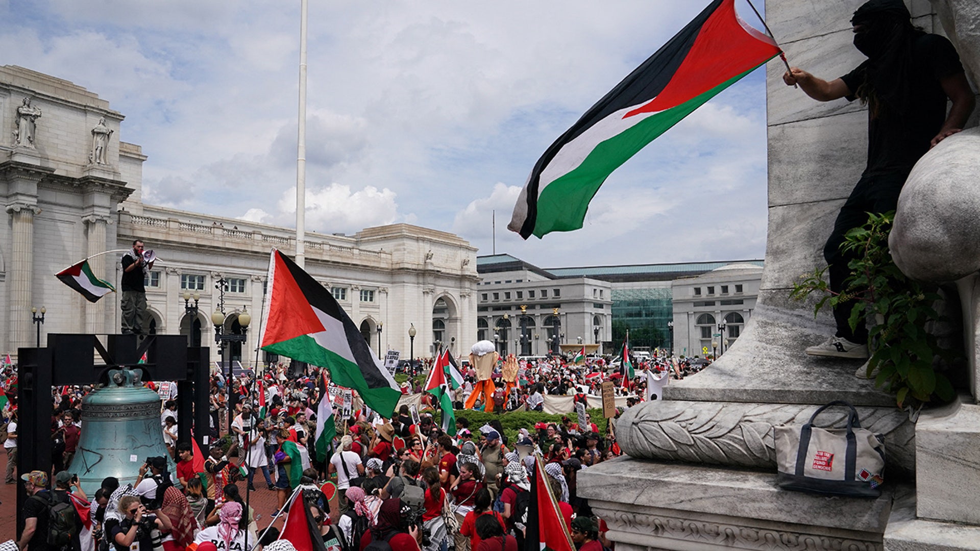 Pro-Palestinian demonstrators wave Palestinian flags outside Union Station