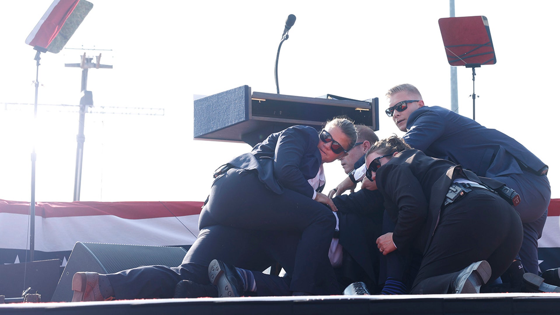 Secret Service agents fall on Donald Trump after he is shot