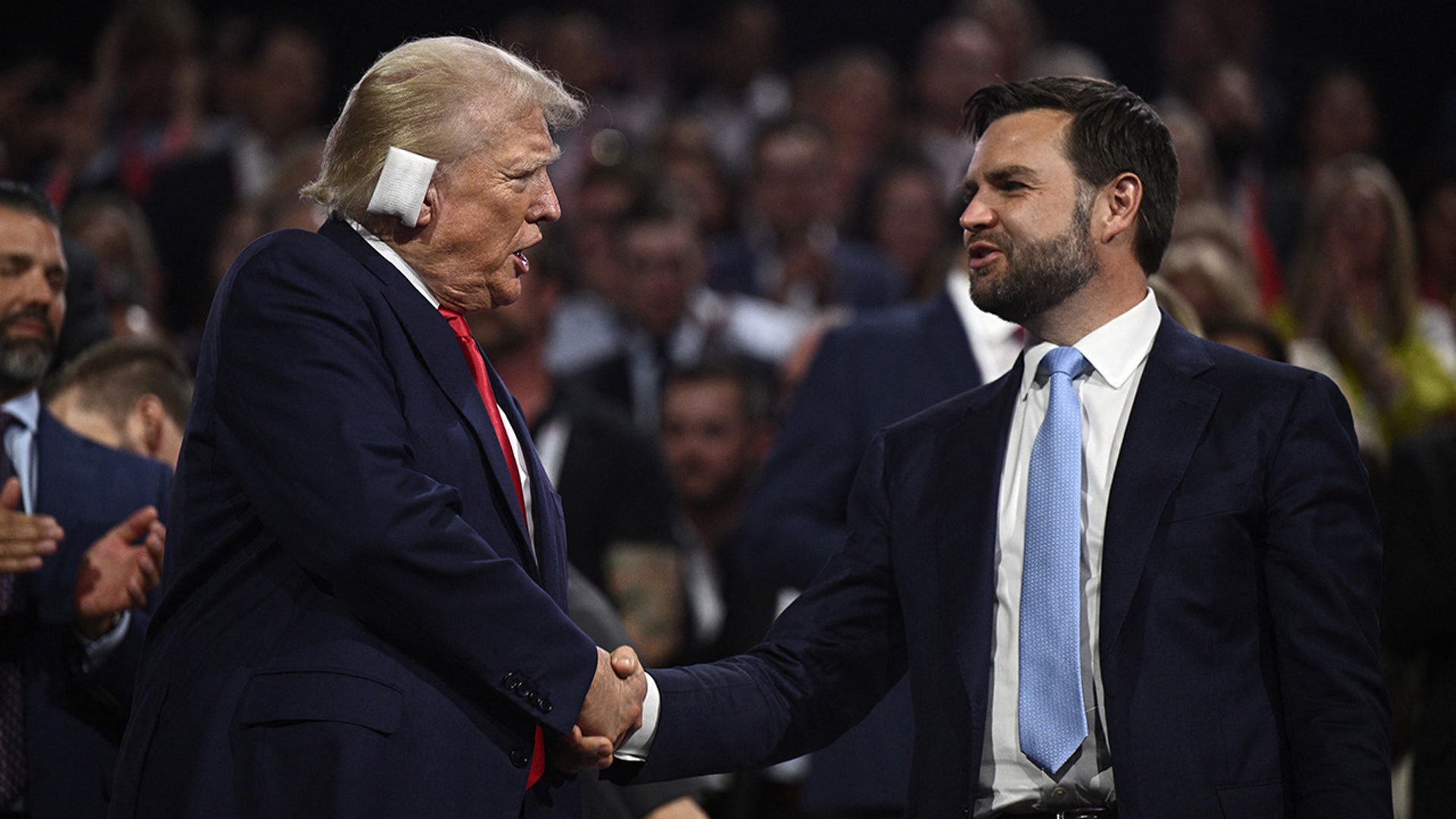 US former President and 2024 Republican presidential candidate Donald Trump shakes hands with US Senator from Ohio and 2024 Republican vice-president candidate JD Vance