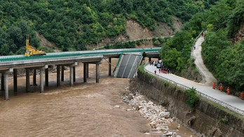 11 dead and dozens missing after a highway bridge in China crumbles in flooding and heavy storms