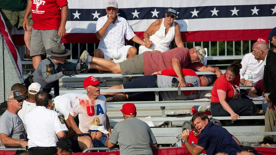 Trump supporters are seen covered with blood in the stands
