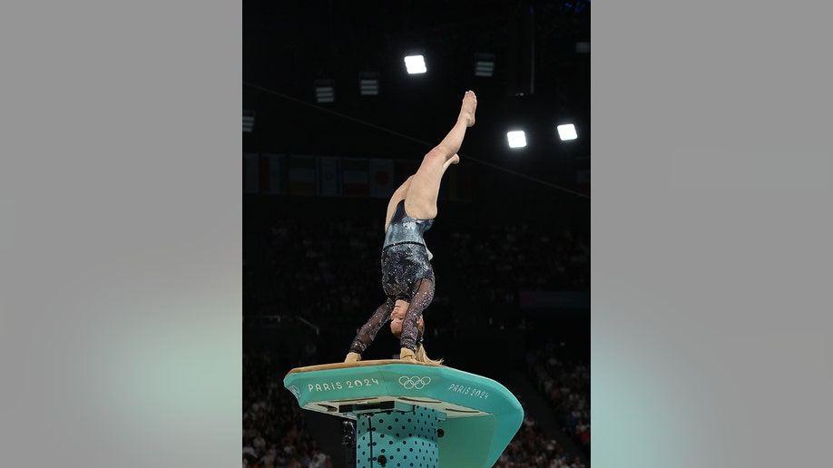 Jade Carey puts her arms on the vault as she's upside down
