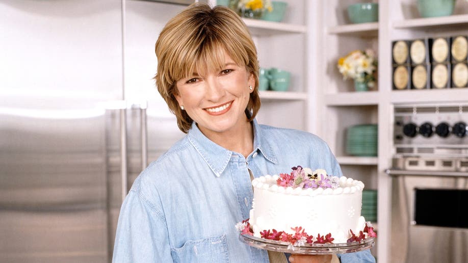 Martha Stewart holding a cake