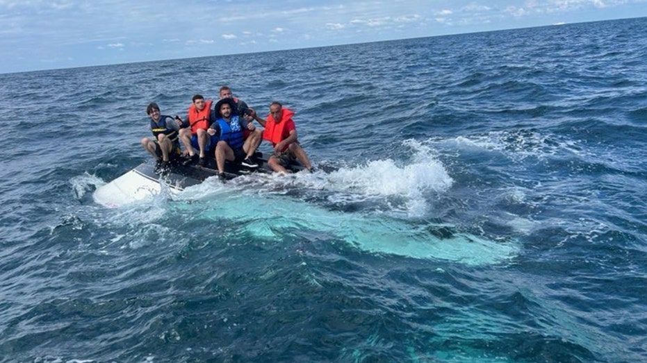 Coast Guard rescues 5 men huddled atop capsized boat 11 miles off Florida coast