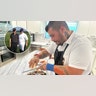 Christos Bisiotis is seen working in his home kitchen in Coral Springs, Florida. Inset photo shows him posing with former President Bill Clinton during a charity event in New Jersey in 2013.