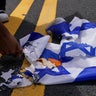 A pro-Palestinian demonstrator burns an Israeli flag, on the day of Israeli Prime Minister Benjamin Netanyahu's address to a joint meeting of Congress, on Capitol Hill in Washington, U.S., July 24, 2024. 