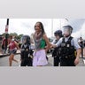 U.S. Park Police officers escort away a handcuffed demonstrator at a pro-Palestinian protest
