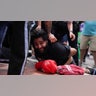 U.S. Park Police officers restrain a demonstrator on the ground at a pro-Palestinian protest