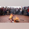 Demonstrators gather around a burning U.S. flag and effigy during a pro-Palestinian protest