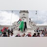Demonstrators gather around the Columbus Memorial Fountain at Union Station