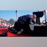 Republican presidential candidate former President Donald Trump is covered by U.S. Secret Service agents