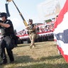 Law enforcement officers move during a rally