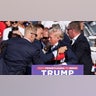 Republican presidential candidate and former U.S. President Donald Trump is assisted by guards during a campaign rally