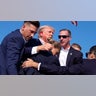 Donald Trump is surrounded by U.S. Secret Service agents at a campaign rally