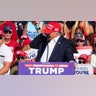 Donald Trump reacts as multiple shots rang out during a campaign rally