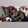 A person is removed by state police from the stands after guns were fired at Republican candidate Donald Trump