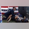 A Secret Service member and members of the crowd are seen at republican presidential candidate former President Donald Trump's rally
