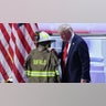Republican presidential nominee and former U.S. President Donald Trump touches the turnout coat of former Buffalo Township Volunteer Fire Department chief Corey Comperatore