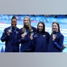 Team USA swimmers pose with silver medals