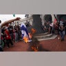 Pro-Palestinian demonstrators burn an Israeli flag, on the day of Israeli Prime Minister Benjamin Netanyahu's address to a joint meeting of Congress, on Capitol Hill in Washington, U.S., July 24, 2024. REUTERS/Nathan Howard