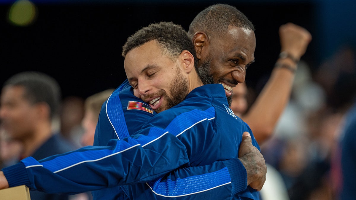 LeBron James hugs Steph Curry