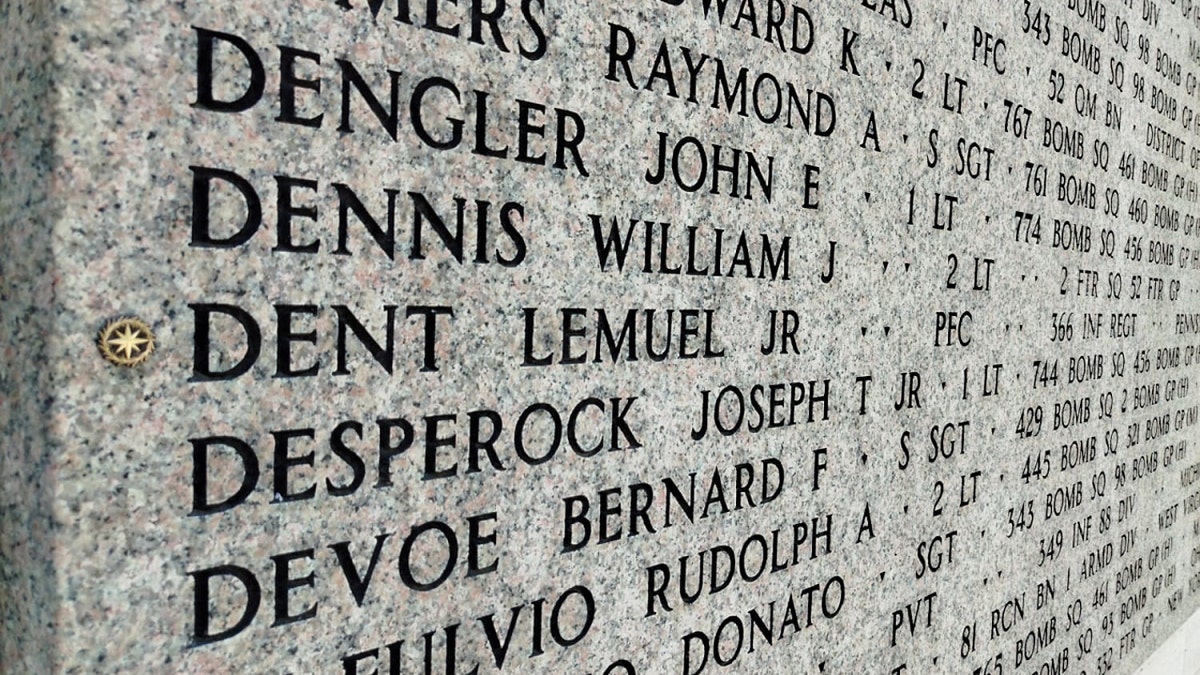 A rosette can be seen next to the name Dent Lemuel Jr. at the Florence American Cemetery in Italy.