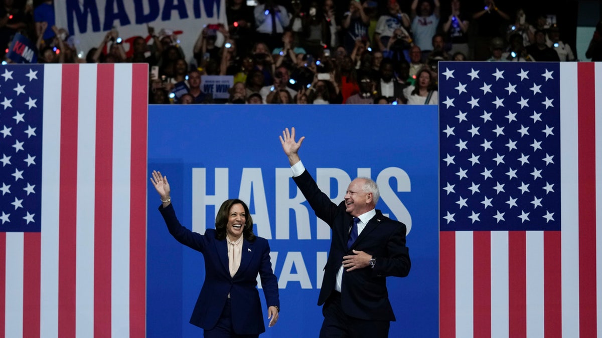 Harris and Walz waving to rallygoers