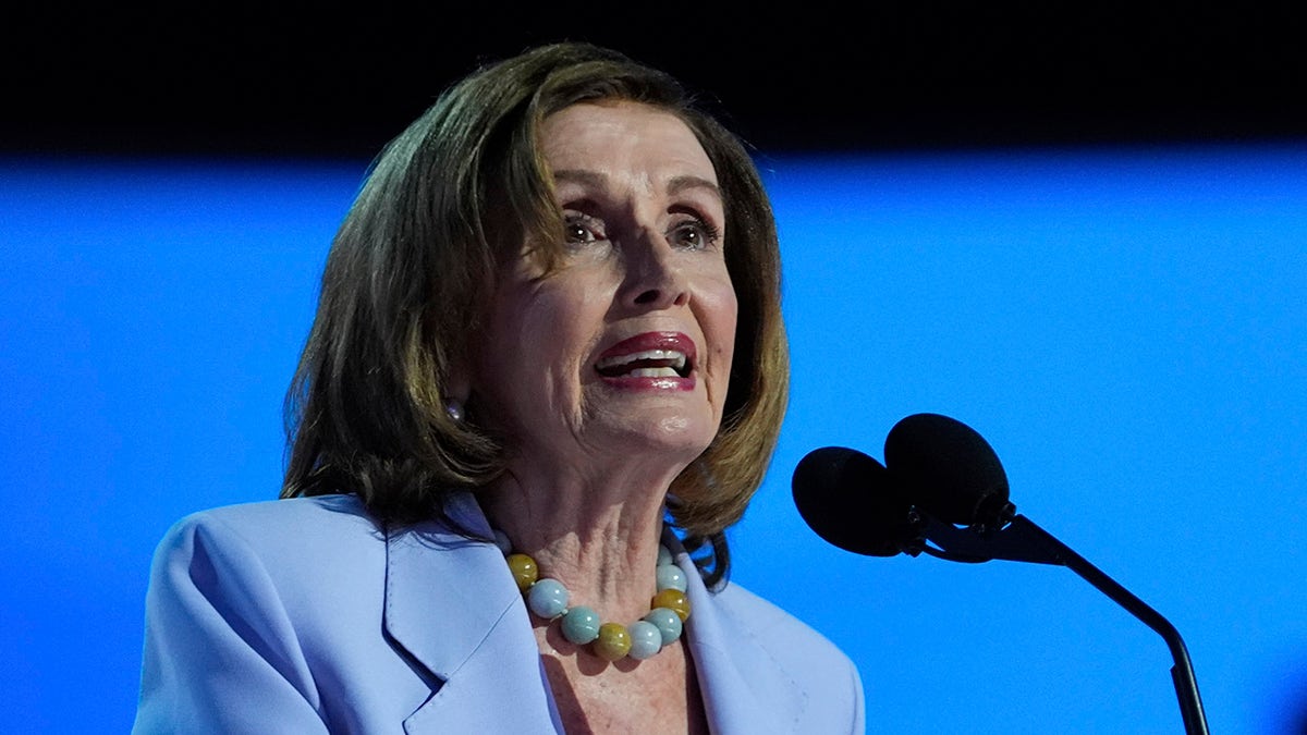 Pelosi at microphone on DNC stage