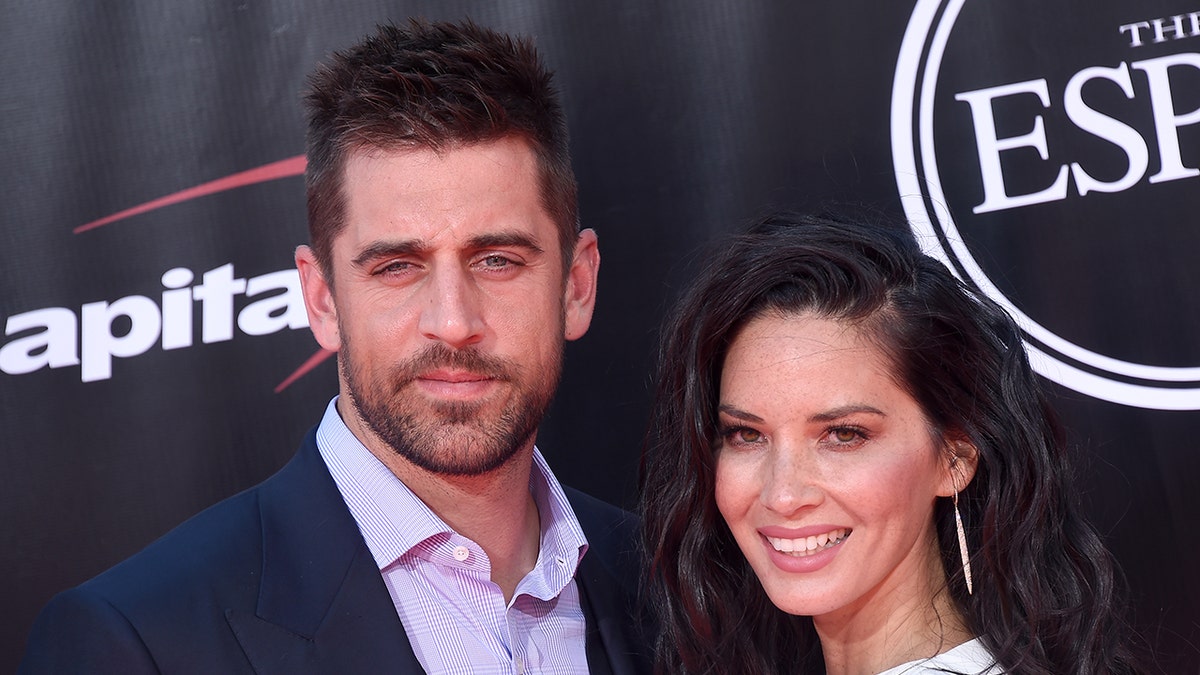 Aaron Rodgers and Olivia Munn pose on red carpet