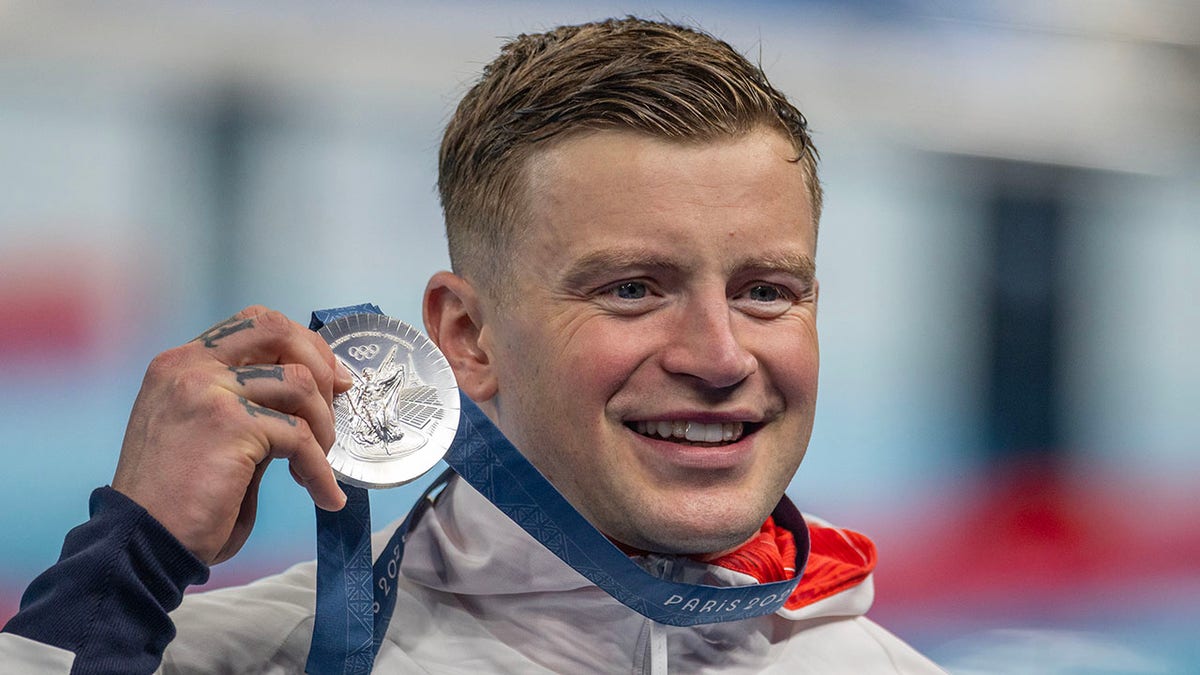 Adam Peaty holds the silver