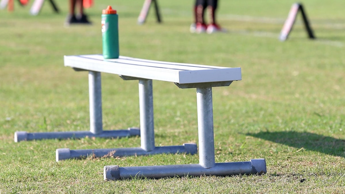 A bench on a football field.