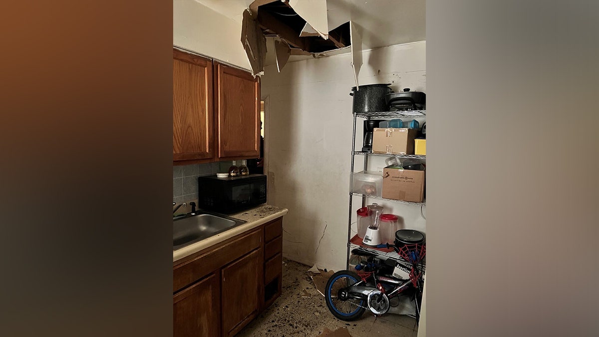 Broken ceiling behind which the suspect was hiding