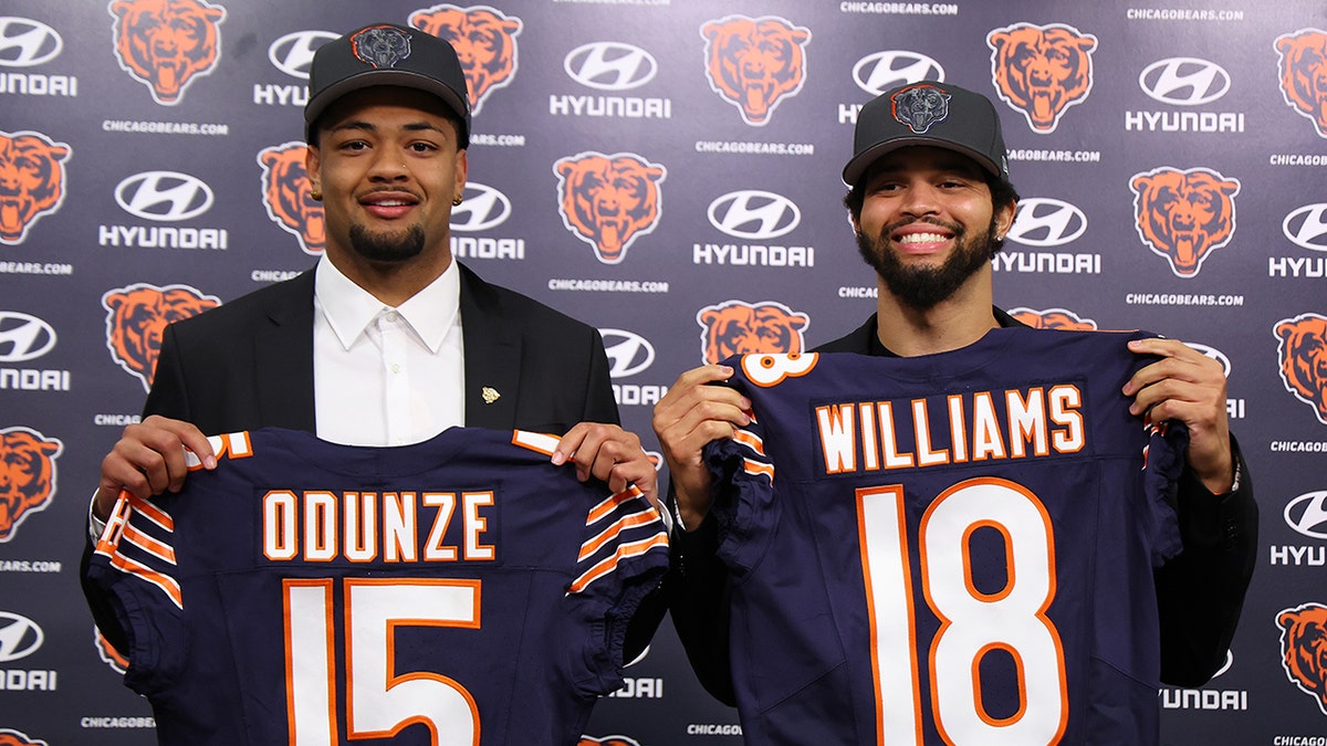 Rome Odunze and Caleb Williams hold up jerseys