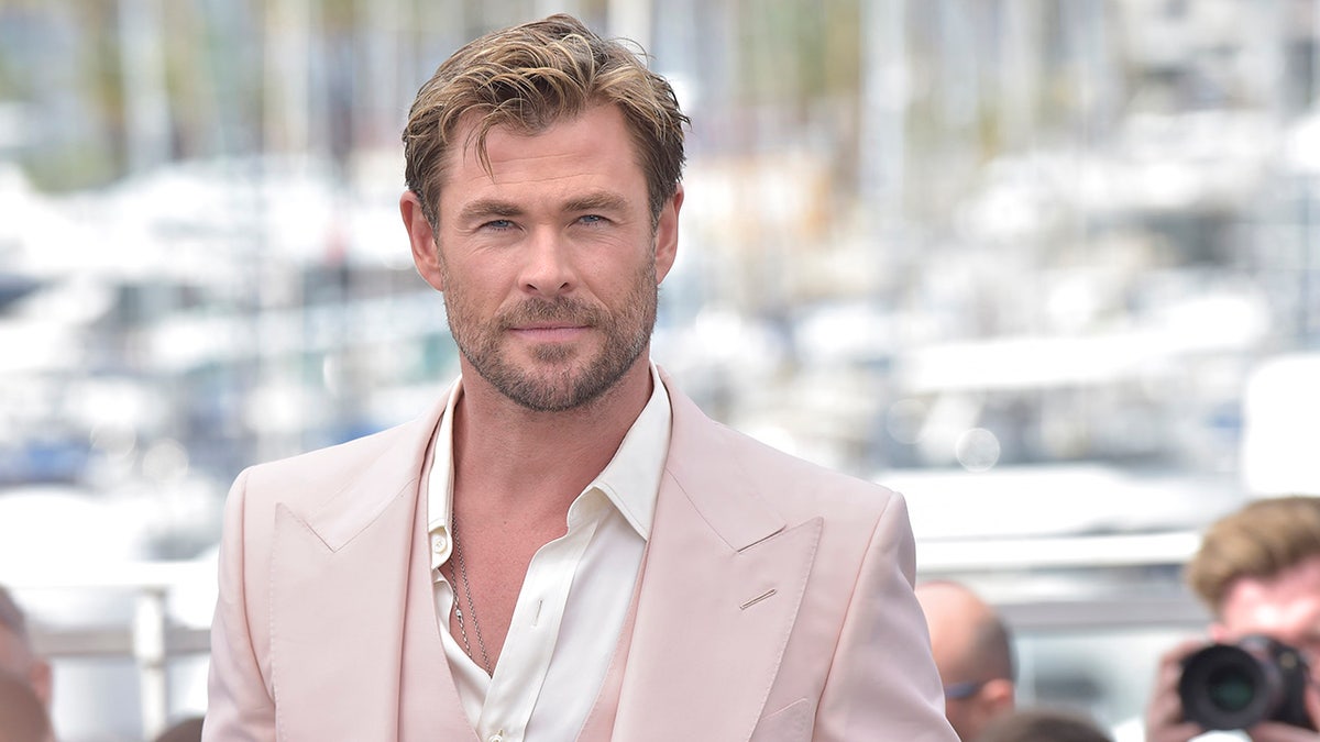 Chris Hemsworth wearing a tan suit