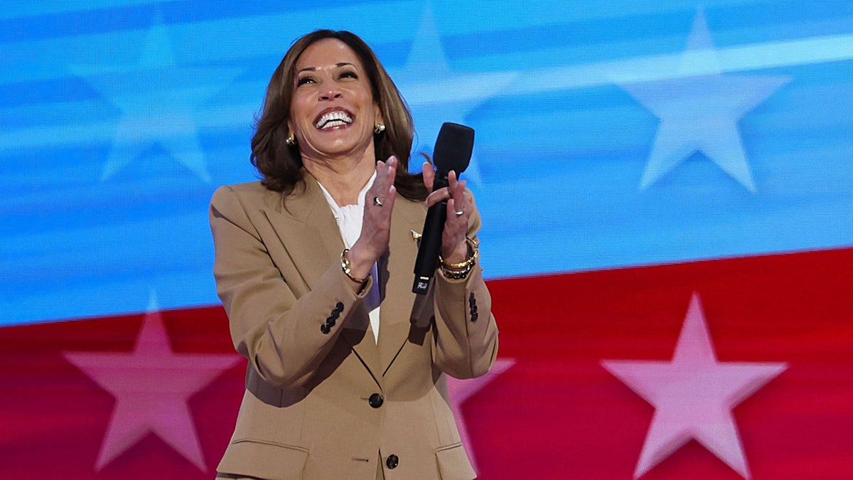 Kamala Harris smiling and clapping at DNC