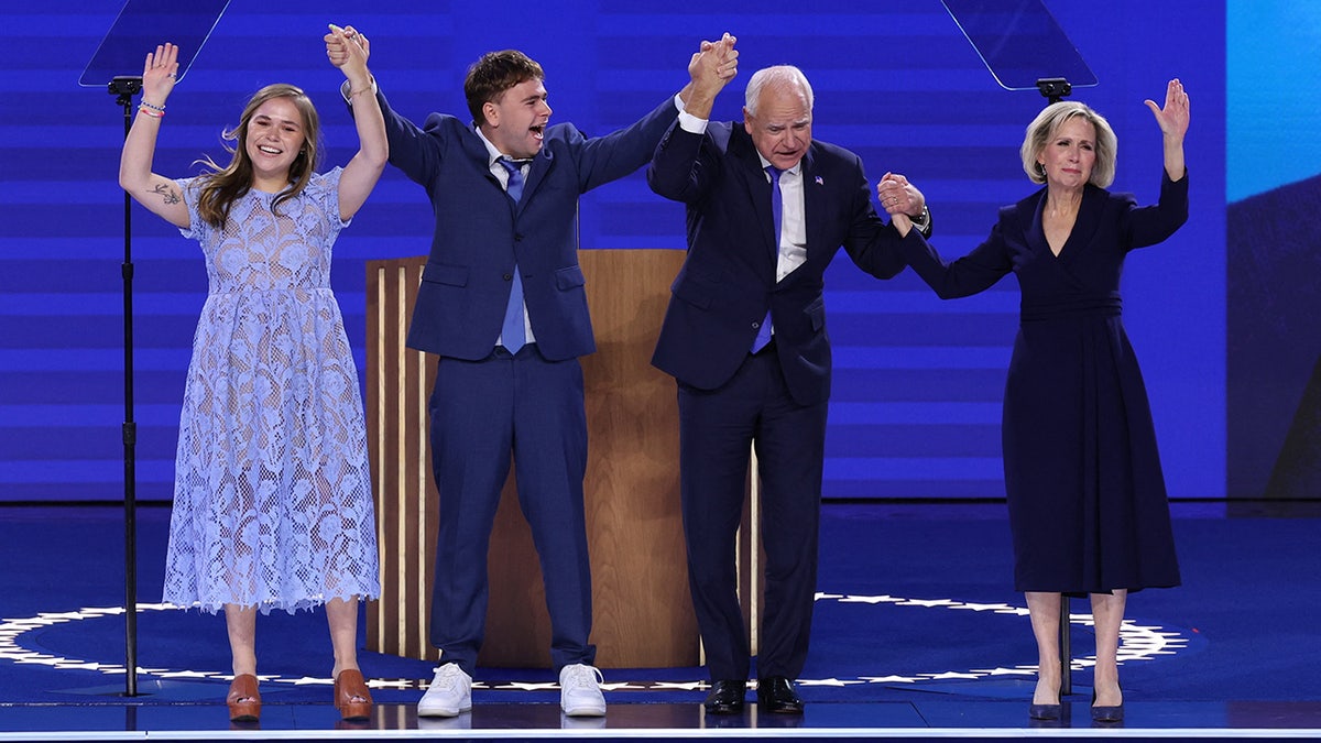 Tim Waltz takes to the stage at the 2024 Democratic National Convention with his wife and children