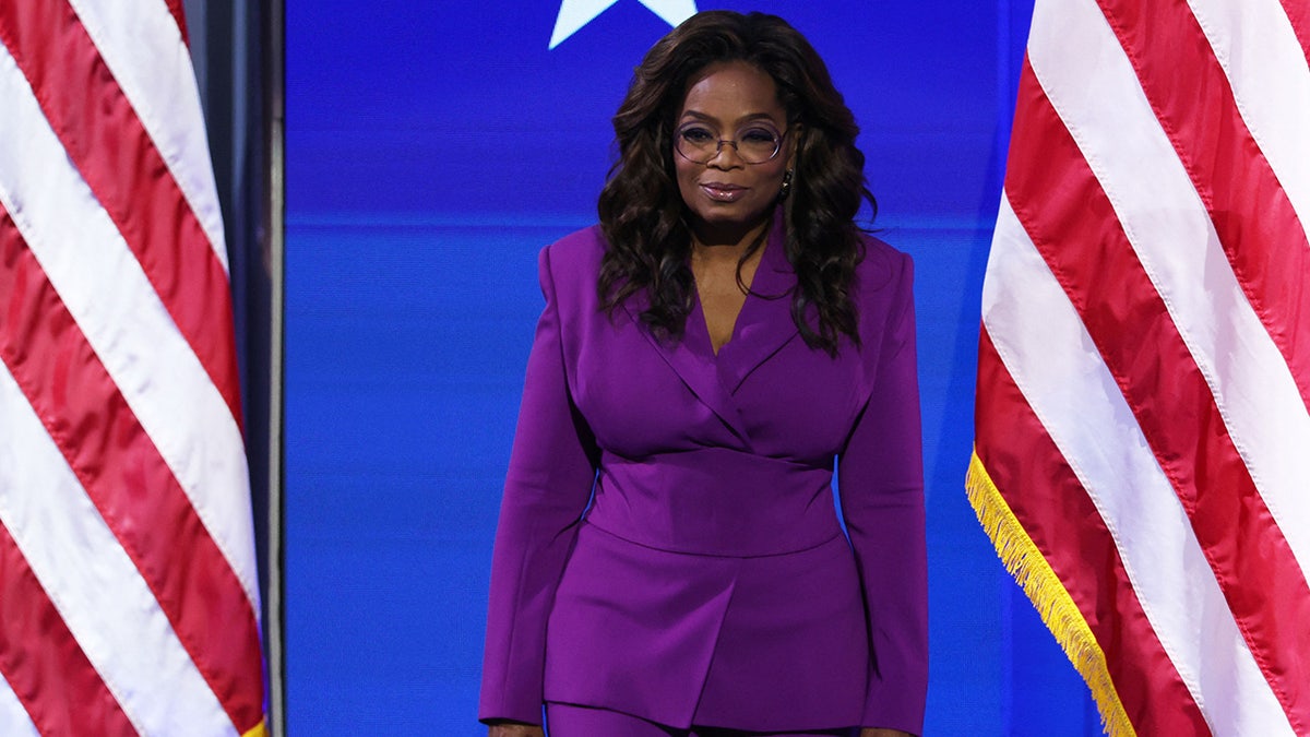 Oprah Winfrey framed by US flags at the 2024 DNC