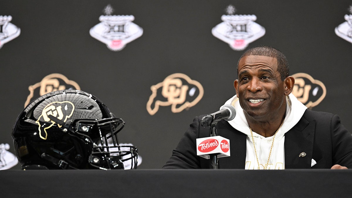 Deion Sanders speaks to reporters