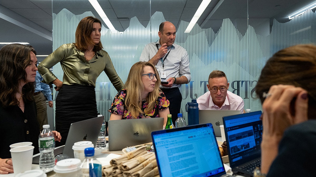 WSJ Editor-in-Chief Emma Tucker and staff celebrate the successful prisoner exchange in Turkey between the United States and Russia