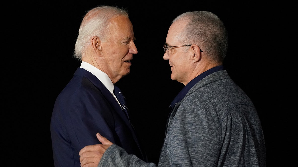 President Joe Biden greets Paul Whelan upon his arrival at Joint Base Andrews