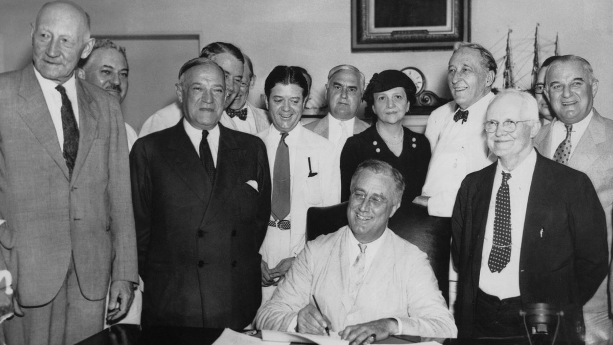 President Franklin D. Roosevelt signs the Social Security Act on Aug. 14, 1935.