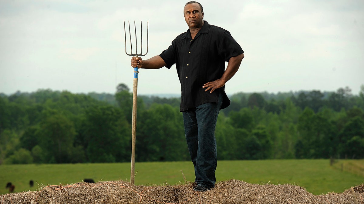 Virginia farmer John Boyd with pitchfork