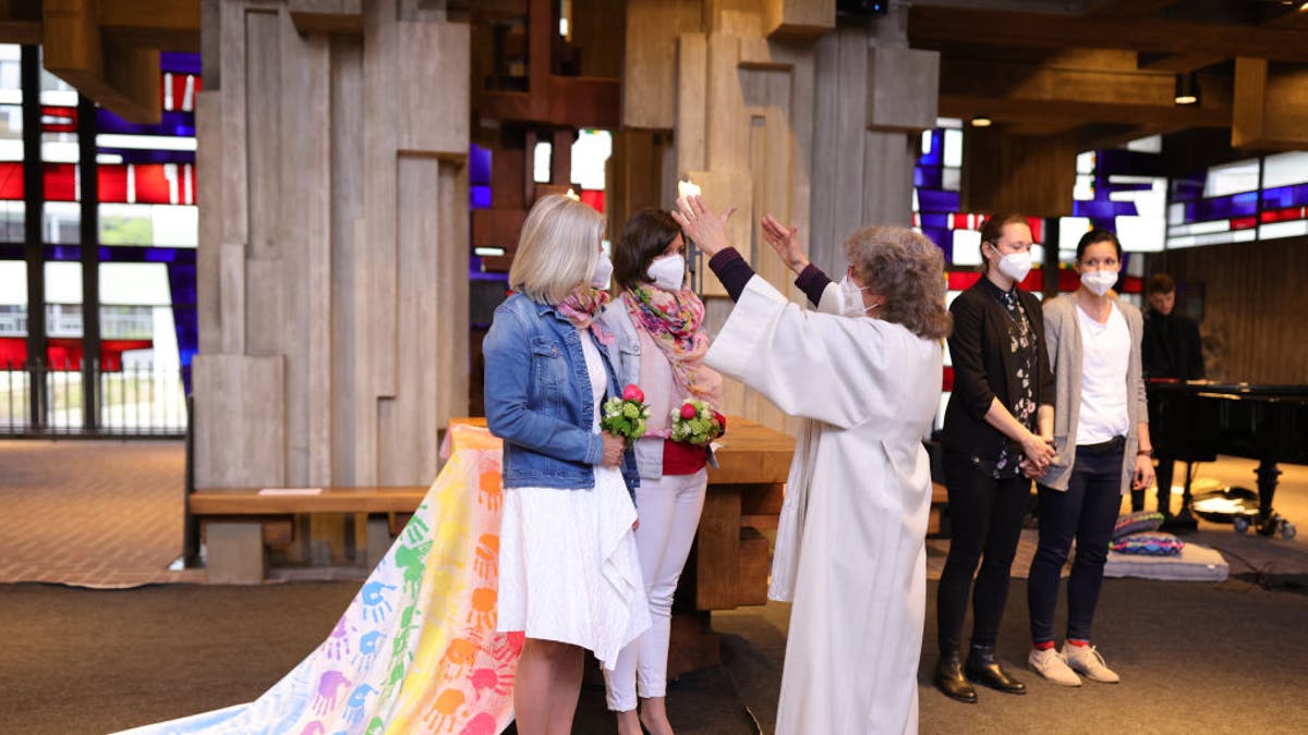 couple blessed by clergy member