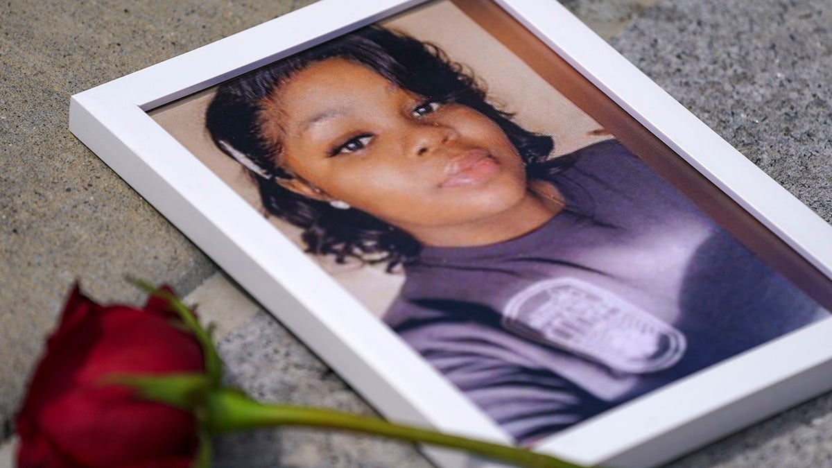 Photo of Breonna Taylor with a rose