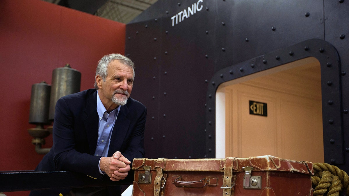 Explorer Paul Henri Nargeolet with a hull reading 'Titanic' behind him