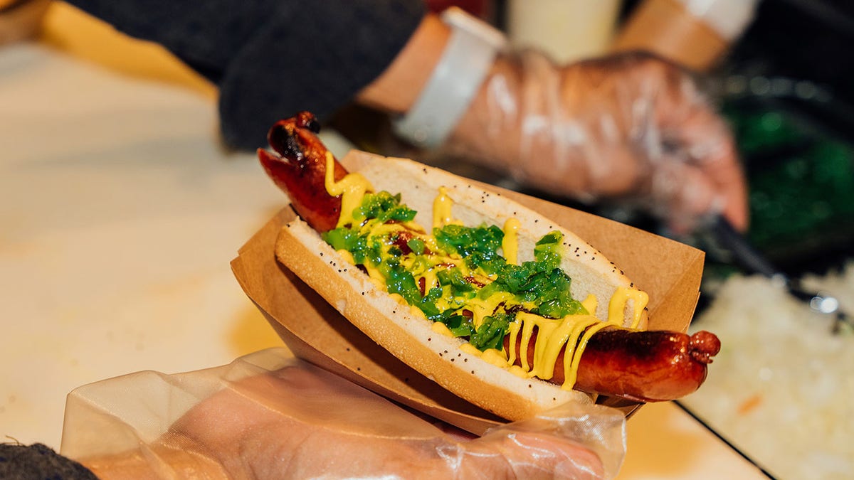 A char-grilled Chicago style hot dog with mustard and relish served at Gold Cost Dogs at O'Hare airport
