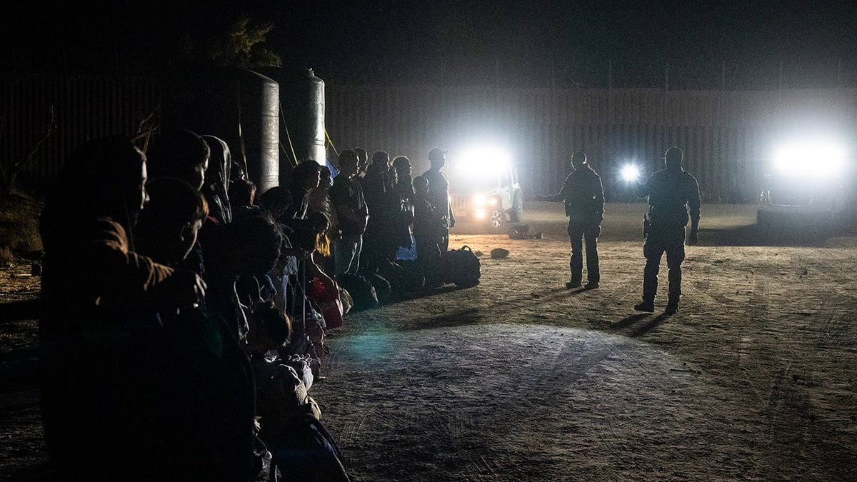 Migrants are processed by U.S. Border Patrol agents after crossing into the U.S. from Mexico through an abandoned railroad on June 28, 2024, in Jacumba Hot Springs, San Diego, California. 